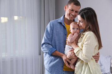 Poster - Happy family with their cute baby at home. Space for text