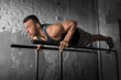 © Syda Productions - fitness, sport, bodybuilding and people concept - young man doing push-ups on parallel bars in gym
