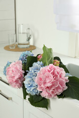 Wall Mural - Beautiful light blue and pink hortensia flowers in kitchen sink