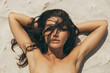 Nude Woman Sunbathing on the Nudist Beach