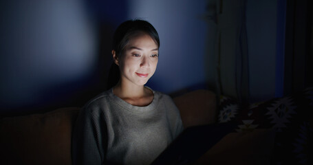 Wall Mural - Woman use of tablet computer at home in the evening