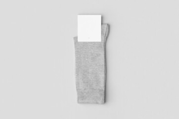 Sticker - Light grey socks mockup with blank label.