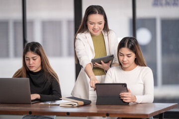 Young Asian college students have meetings with a teacher advisor or a tutor to discuss the project