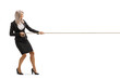 Full length profile shot of a young attractive businesswoman pulling a rope