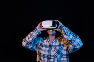 Young woman wearing virtual reality glasses for the first time.