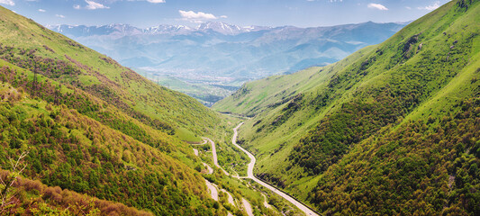 Aerial view of a mountain road in a gorge between two mountain ranges