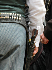 Wall Mural - Vertical shot of a male with a revolver and bullets