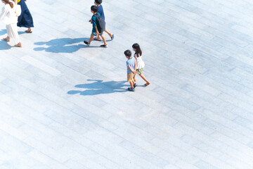 Wall Mural - Top view of group family mothers and kids walking at pedestrian walkway outdoor for traveling or exercise healthy. Crowd people at background landscape public street in city. Girl and boys are funny.