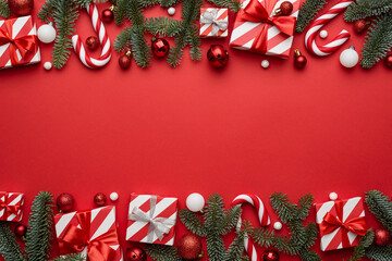 Wall Mural - christmas background with a frame decorated with festive gifts and fir branches