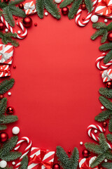 Wall Mural - Red background with Christmas gift boxes and Christmas decorations frame