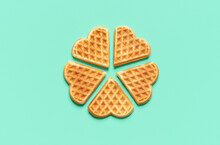 Heart Shaped Waffles Top View On A Green Table. Belgian Waffles Isolated On A Colored Background.