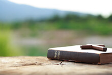 A Wooden Cross On Holy Bible On Wooden Table. Sunday Readings, Bible Education. Spirituality And Religion Concept.