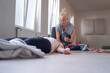 © lorenzophotoprojects - Yoga instructor, bathing a student's head, with essential oils, during a group class.