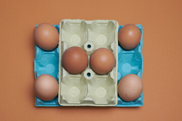 Eggs in an egg carton with orange background