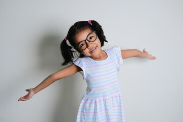 Wall Mural - Asian little girl open her arms and showing happy face expression