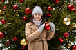 Happy young woman with christmas tree decoration