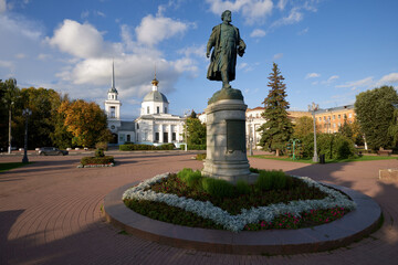 Beautiful city Tver landscape view of monument to Afanasy Nikitin on river Volga embankment with Resurrection church and sky, trees and russian buildings. Small city architecture concept. Tver, Russia