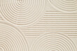 © yrabota - Pattern in Japanese Zen Garden with concentric circles on sand for meditation and tranquility