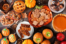Fall Desserts Table Scene With A Mixture Of Sweet Autumn Treats. Top Down View Over A Dark Wood Background.