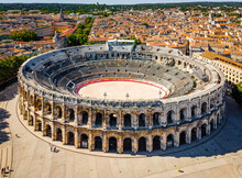 The Aerial View Of Arena Of Nîmes, An Old Roman City In The Occitanie Region Of Southern France