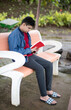 © IVAN - Young boy sitting on a bench and reading a book