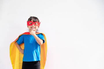 Wall Mural - Little child girl plays superhero. Child on the white background. Girl power concept