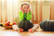 © alexkich - Little child choose a pumpkin at autumn. Child sitting on giant pumpkin. Pumpkin is traditional vegetable used on American holidays - Halloween and Thanksgiving Day.