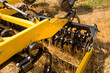 close up of a disc harrow cultivator at work on a field background