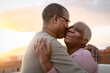 © Alessandro Biascioli - Happy Latin senior couple having romantic moment embracing on rooftop during sunset time - Elderly people love concept