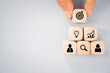 © Ratana21 - hand placed cube with dartboard icon on top of business icon to complete pyramid shape for brainstorming, cooperation or coworker to reach goal concept