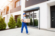 © romaset - Young delivery man hold a cardboard box in his hands
