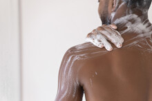 Cropped Close Up Male Body Part, Back And Shoulder Of African Man Take Shower Wash Body Use Soap, Hydrating Gel, Do Morning Self-hygiene Routine. Skincare, Bodycare Product For Men, Healthcare Concept