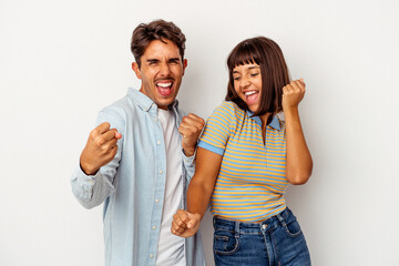 Young mixed race couple isolated on white background dancing and having fun.