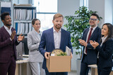 Fototapeta Na sufit - Group of intercultural colleagues clapping hands to new employee carrying box with supplies
