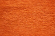 Textil-Hintergrund von einem orangen Frottee-Handtuch