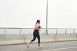 © Seventyfour - Rear view of young athlete running in the morning along the road on fresh air