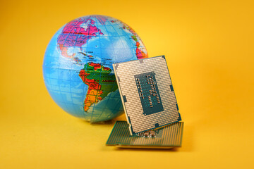 World globe and microprocessors against an orange background