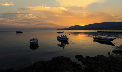 Wall Mural - Dikili -Izmir - Turkey 15.August 2021 Boats on the sea in Bademli neighborhood at sunset