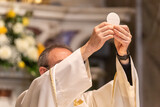 Fototapeta Miasta - The Holy Bread in the rite of Eucharist