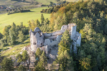 Aerial View Of Medieval Blatnica Gothic Hilltop Castle Ruin Above The Village In A Lush Green Forest Area With Towers And Restoration Work In Slovakia