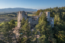 Aerial View Of Medieval Blatnica Gothic Hilltop Castle Ruin Above The Village In A Lush Green Forest Area With Towers And Restoration Work In Slovakia