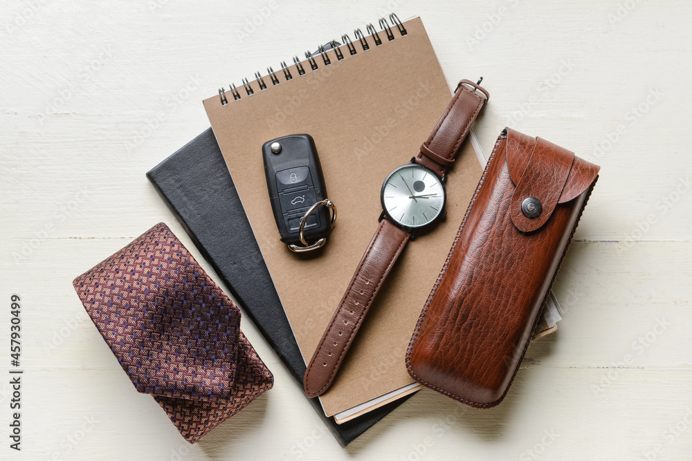 Set of male accessories on light wooden background