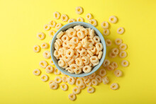 Corn Rings In Glaze For Breakfast On A Colored Background.