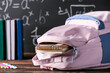 © Pixel-Shot - Stylish school backpack on table in classroom, closeup