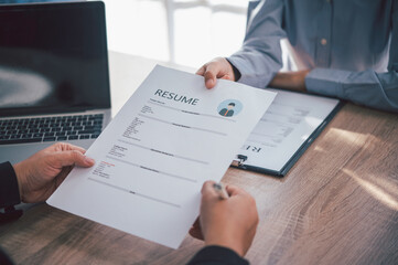 Wall Mural - Human resource manager Is explaining the job to the job seeker before filling out a resume on the application form to consider accepting for employment in the company..