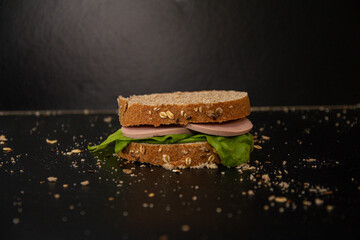 Poster - Closeup shot of a sandwich with lettuce and ham on a table