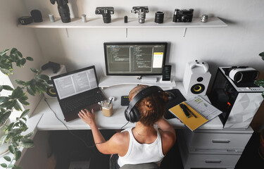 girl programmer in the modern developer workplace for writing code with white computer desktop and c