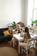 © diignat - Mom, I can share everything with you. Mother and her daughter are sitting in the kitchen having a cup of tea and talking.