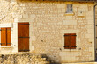 Stone building with shutters window, France