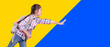 © Tom Wang - Happy student girl with school bag. Running and touching something. Isolated on yellow and blue background.